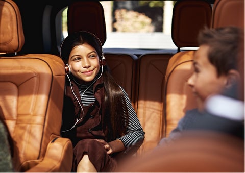 Two young people are comfortably seated in the second and third rows of a Lincoln Aviator® SUV | Oliver Lincoln in Plymouth IN