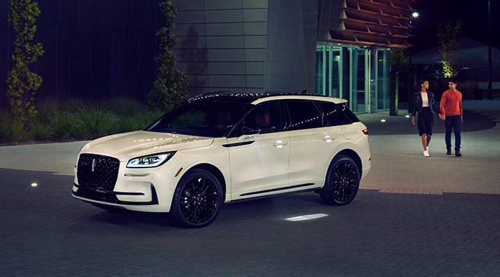 Two people approach a 2024 Lincoln Corsair® SUV featuring the available Jet Appearance Package. | Oliver Lincoln in Plymouth IN