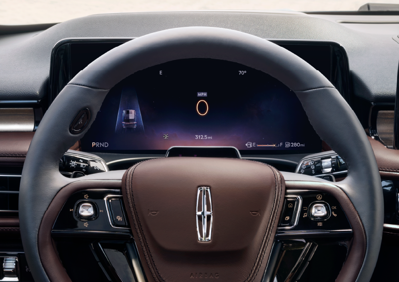 The steering wheel of 2025 Lincoln Aviator® SUV is shown with black and brown accents. | Oliver Lincoln in Plymouth IN