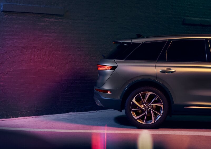 A dramatization of a 2025 Lincoln Corsair® SUV is shown backing up toward a wall. | Oliver Lincoln in Plymouth IN