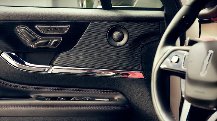 A Revel® audio speaker is shown in the driver's side door of a 2025 Lincoln Corsair® SUV. | Oliver Lincoln in Plymouth IN