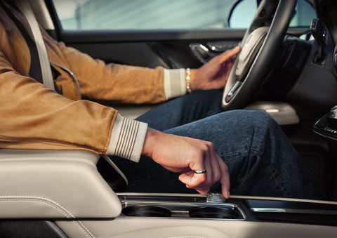 The driver of a 2024 Lincoln Corsair® SUV is shown selecting the drive mode. | Oliver Lincoln in Plymouth IN