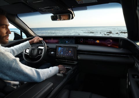 A driver of a parked 2025 Lincoln Nautilus® SUV takes a relaxing moment at a seaside overlook while inside his Nautilus. | Oliver Lincoln in Plymouth IN