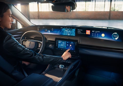 The driver of a 2025 Lincoln Nautilus® SUV interacts with the center touchscreen. | Oliver Lincoln in Plymouth IN