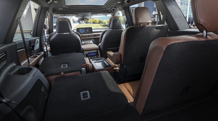 One side of the PowerFold® third-row seat and a second-row seat are folded forward in the 2026 Lincoln Aviator® SUV. | Oliver Lincoln in Plymouth IN