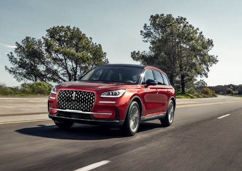 A 2026 Lincoln Corsair® SUV is shown being driven on a country road. | Oliver Lincoln in Plymouth IN