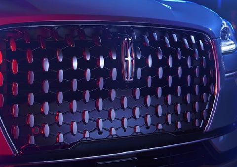 The grille of a 2025 Lincoln Corsair&reg; SUV reflects neon light at night. | Oliver Lincoln in Plymouth IN