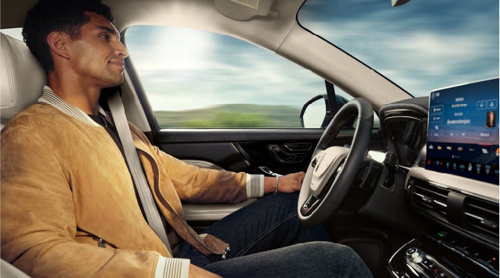 A person is shown using Lincoln BlueCruise hands-free highway driving technology on a divided highway in a hands-free Blue Zone. | Oliver Lincoln in Plymouth IN