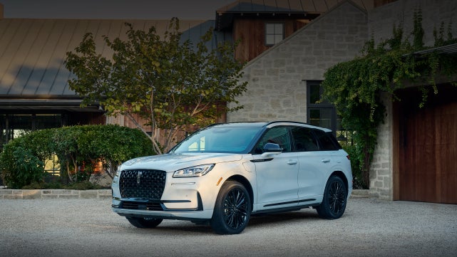 A 2026 Lincoln Corsair® SUV is parked in front off a luxury home. | Oliver Lincoln in Plymouth IN