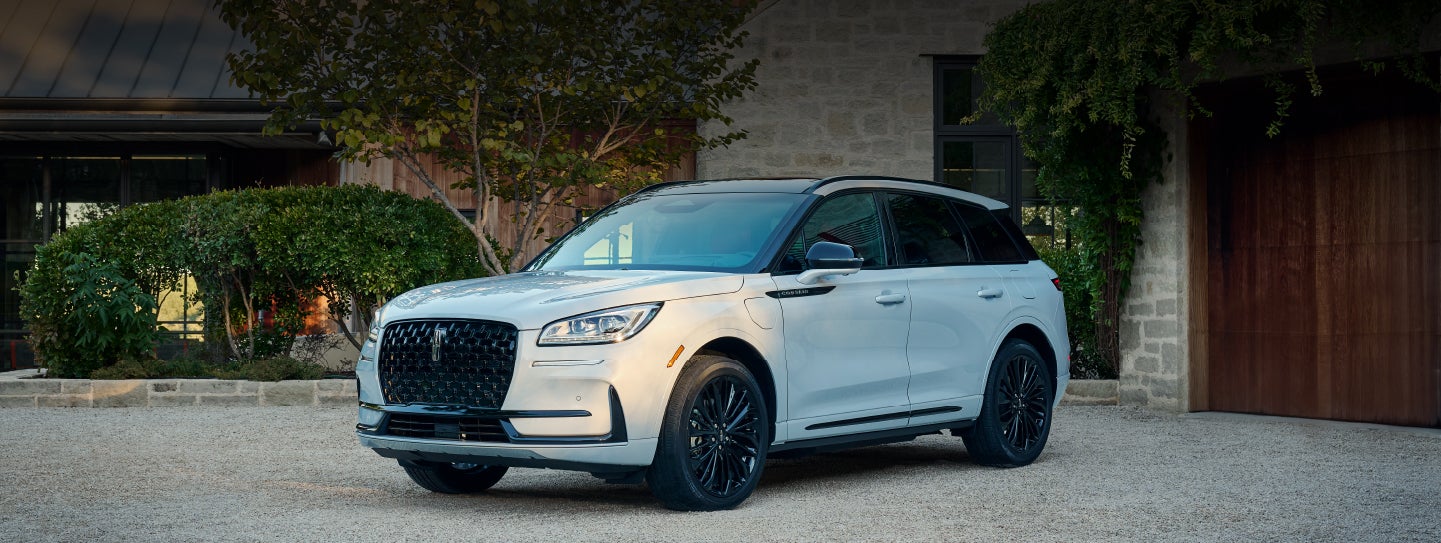 A 2026 Lincoln Corsair® SUV is parked in front off a luxury home. | Oliver Lincoln in Plymouth IN