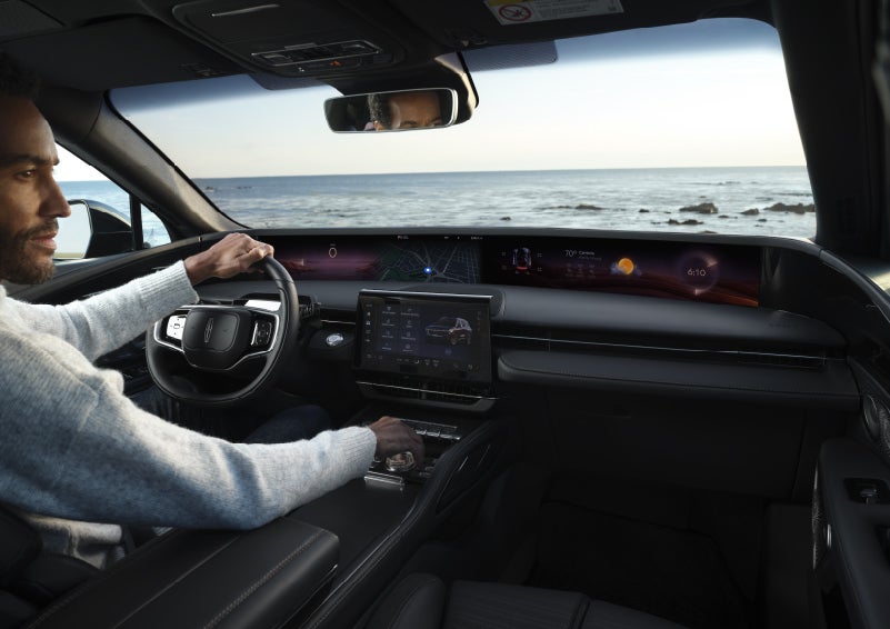 A driver of a parked 2026 Lincoln Nautilus® SUV takes a relaxing moment at a seaside overlook while inside his Nautilus. | Oliver Lincoln in Plymouth IN