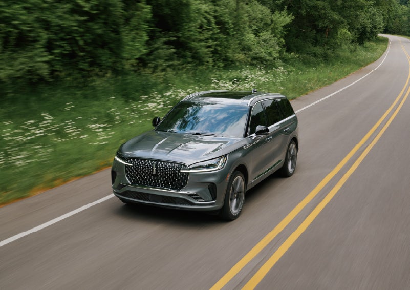 A 2027 Lincoln Aviator® SUV is being driven down a road. | Oliver Lincoln in Plymouth IN