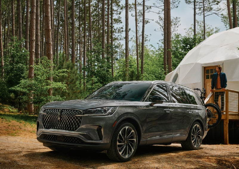 A 2027 Lincoln Aviator® is parked next to a high end glamping site. | Oliver Lincoln in Plymouth IN