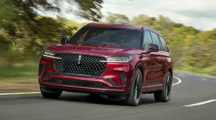 A 2027 Lincoln Aviator® SUV is being driven on a country road | Oliver Lincoln in Plymouth IN