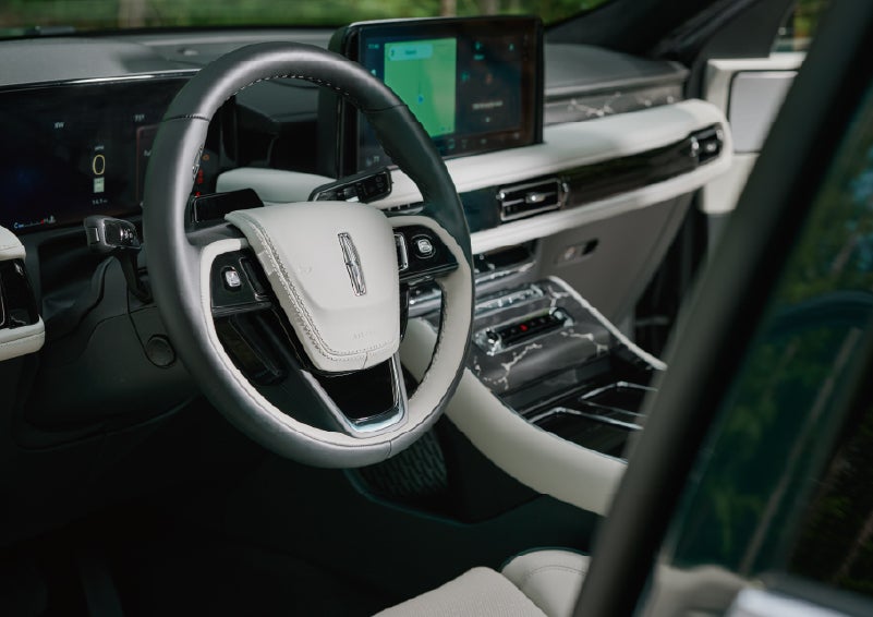The leather-trimmed steering wheel of a 2027 Lincoln Aviator® Black Label™ SUV. | Oliver Lincoln in Plymouth IN