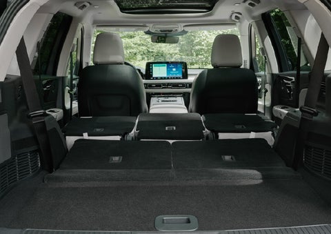 A rear to front view of the interior of a 2027 Lincoln Aviator® Black Label™ SUV shows the third and second rows folded flat | Oliver Lincoln in Plymouth IN