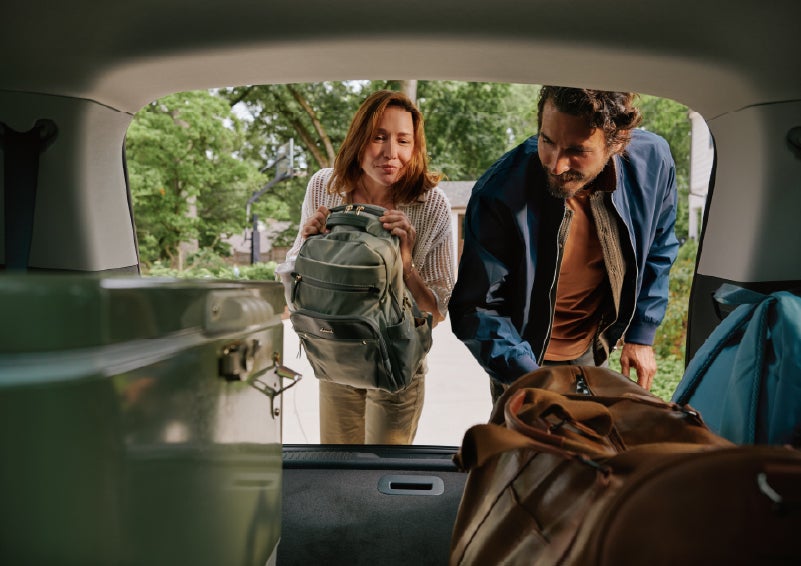 A couple loads luggage into the rear of a 2027 Lincoln Aviator® Black Label™ SUV..e 202 | Oliver Lincoln in Plymouth IN