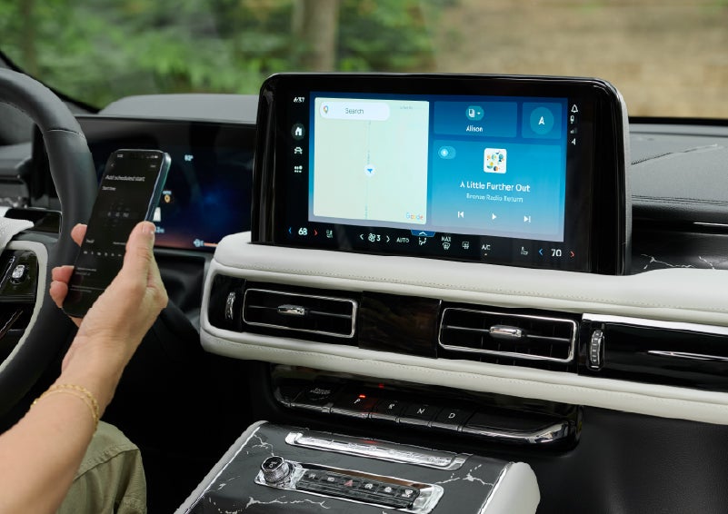 A person pairs thier phone with the center touchscreen of a 2027 Lincoln Aviator® Black Label™ SUV | Oliver Lincoln in Plymouth IN
